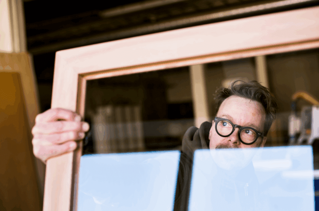 Man inspecting a wooden frame