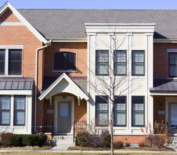 Modern townhouse exterior in sunlight.
