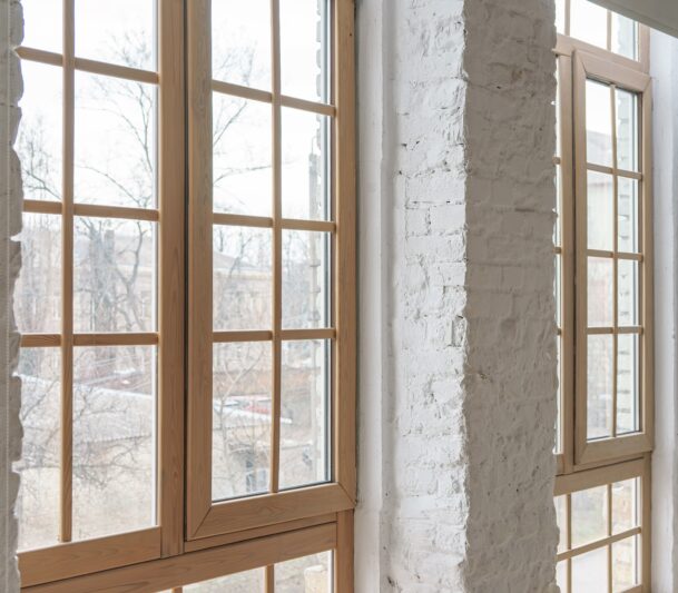 Modern wooden windows in a brick wall.