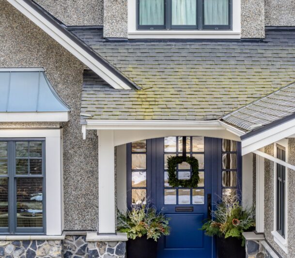 Front door with wreath and plants