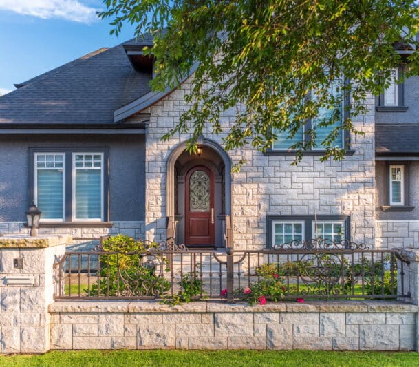 Modern stone house with wrought iron gate