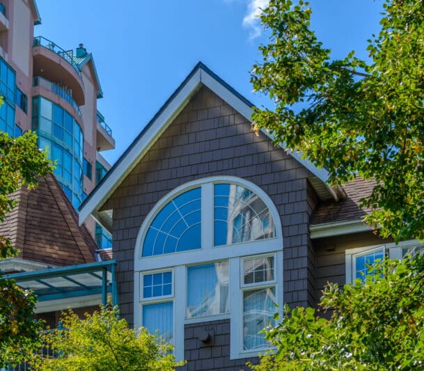 Home with arched replacement window and trees in Pickering