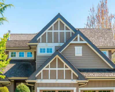 Craftsman-style home exterior with small gable windows and Tudor-inspired trim, small window replacement ideas