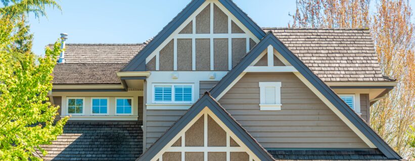 Craftsman-style home exterior with small gable windows and Tudor-inspired trim, small window replacement ideas