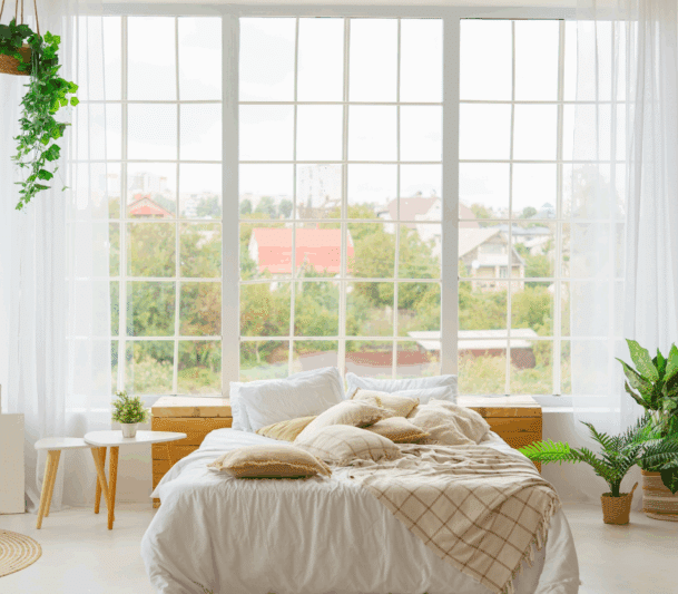 Cozy bedroom with large window view.