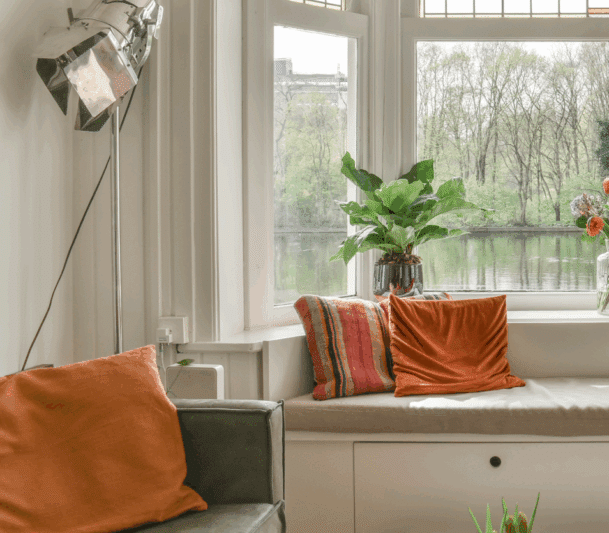 Cozy nook with river view and plants.
