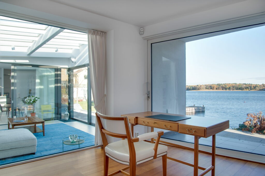 modern home interior with large energy-efficient sliding glass doors and picture window overlooking lake, Canada window and door rebates 2026