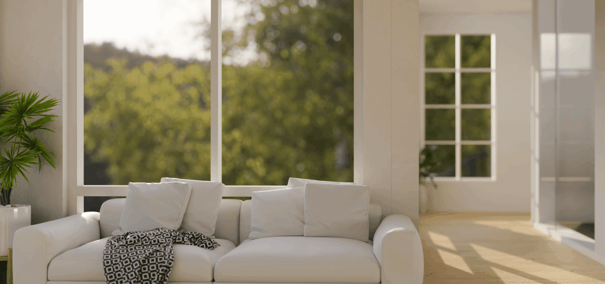 Cozy white sofa by large window