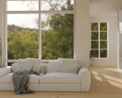 Cozy white sofa by large window