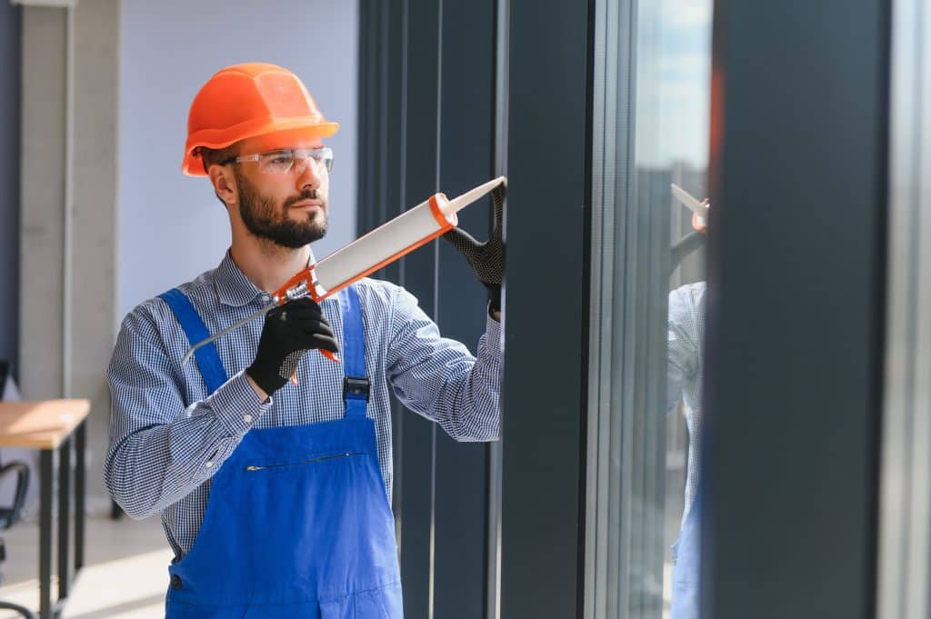 man doing window repair