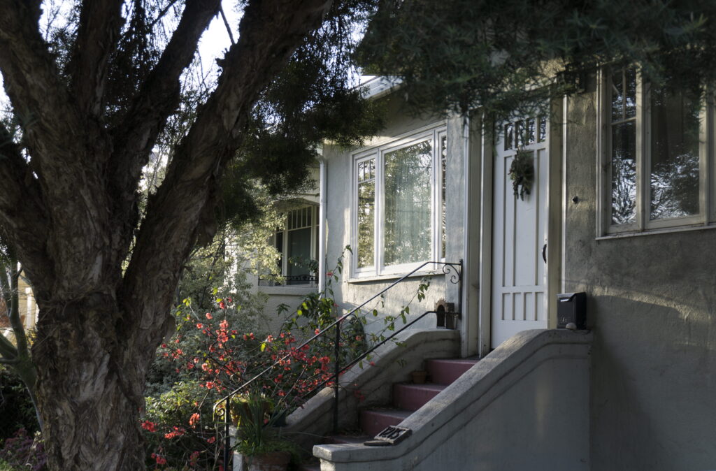 older Canadian home exterior with white casement windows eligible for 2026 window replacement rebates
