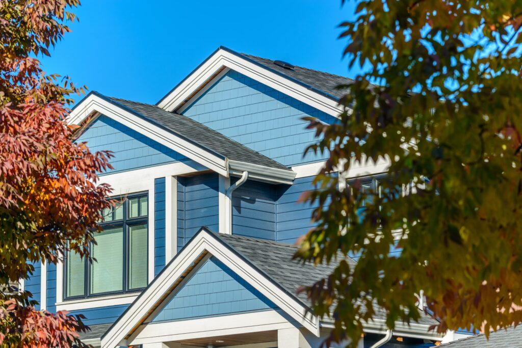 Blue house with autumn trees around.