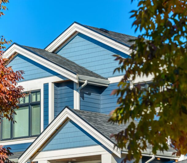 Blue house with autumn trees around.