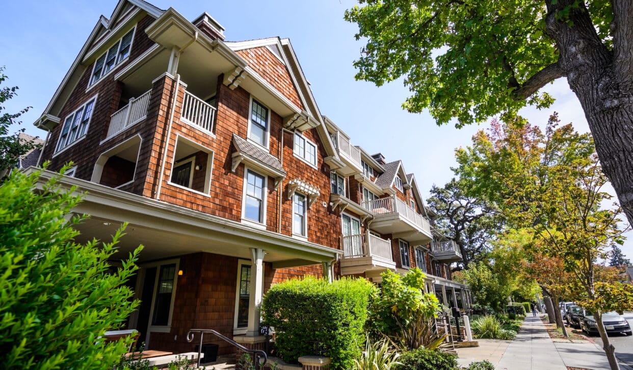 Large brown apartment building in suburb.