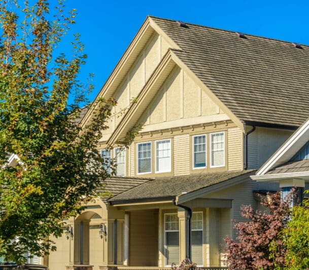 Suburban home with trees in front.