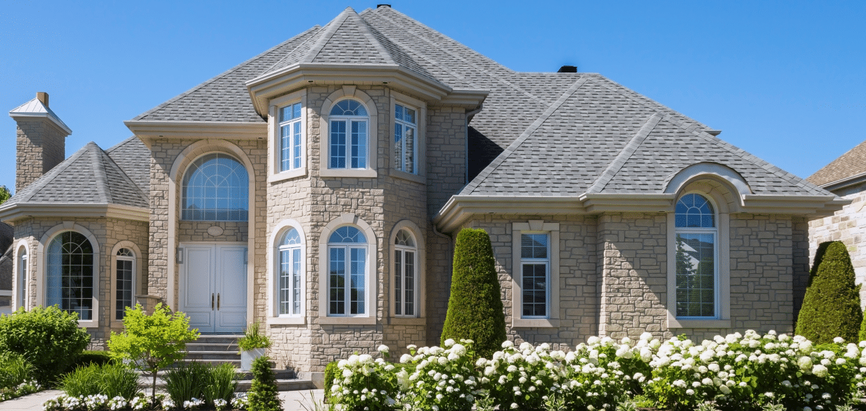 Stone house with large windows.