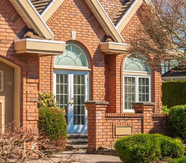Red brick house with arched replacement windows in Georgetown