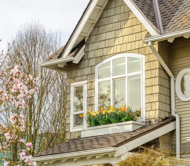 Spring flowers on cottage balcony with replacement window in Canada