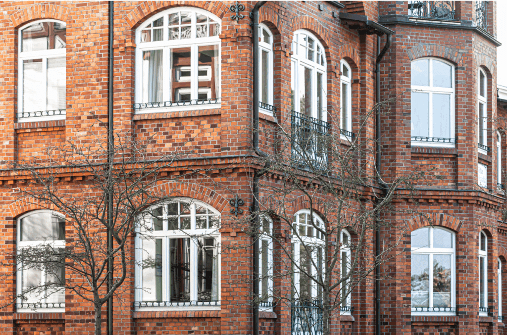 Red brick building with large windows.