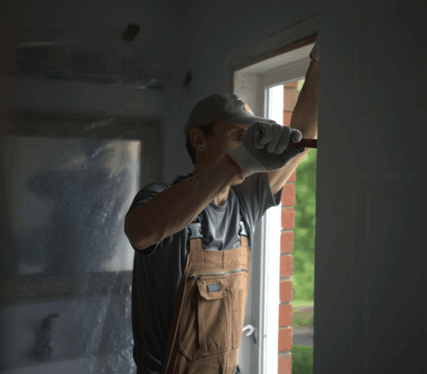 Worker installing a window frame